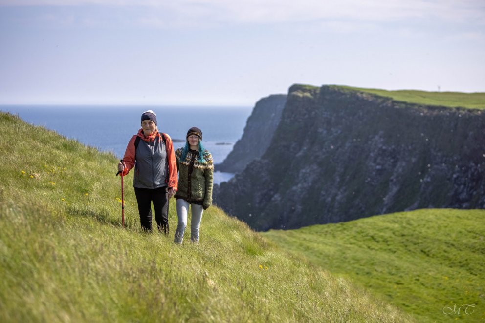 Hiking on the island of Grímsey, by the Arctic Circle. Grímsey is a part of the Arctic Coast Way.  P…